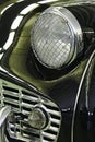 Detail of front mask and headlight with steel cage protection of vintage british sports car roadster Royalty Free Stock Photo