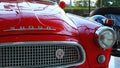 Detail of front mask and left headlight of veteran Czechoslovak car Skoda Felicia from year 1961, red colour.