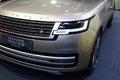 Detail of front mask and lit LED day lighting on new british luxurious 4x4 SUV car Range Rover L460, beige metallic colour