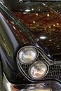 Detail of front mask, massive grille and typical twin round headlights of Lincon Continental Mark V, luxury limousine from 1960