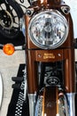 Detail of front mask with round headlight, front suspension fork and round orange winkers of indian made revival of british bike