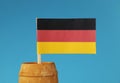 A detail on Germany national flag on wooden stick in wooden barrel