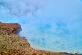 Detail of giant pools of blue covered in sulfur steam in Yellowstone