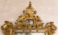 Detail of gilded frame of an antique mirror. Royalty Free Stock Photo