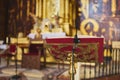Golden lectern with book and microphone on a church altar