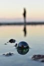 A detail of a glass bead in the water reflection Royalty Free Stock Photo