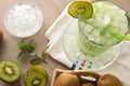 Detail of glass of kiwi juice with ice on table