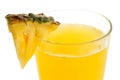 Detail of glass of pineapple juice with a fresh pineapple. Royalty Free Stock Photo