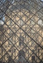 Detail of Glass pyramid in fron of The historical palace building at the Louvre museum in Paris Royalty Free Stock Photo