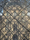 Detail of Glass pyramid in fron of The historical palace building at the Louvre museum in Paris Royalty Free Stock Photo