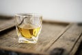 Detail of a glass of whisky on an old shabby wooden barrel Royalty Free Stock Photo