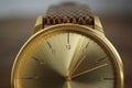 Detail of a golden watch with indented gold-plated crown as a symbol of time or exactness Royalty Free Stock Photo