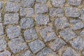 Granite cobblestone pavement of old town, texture background. Top view stone road Royalty Free Stock Photo