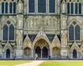 Detail of the Great West Front of Salisbury Cathedral with passers-by Royalty Free Stock Photo