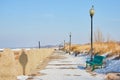 Detail of green bench on walkway in winter Royalty Free Stock Photo