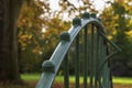 Detail of a green iron railing on a bridge in a park Royalty Free Stock Photo