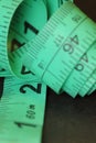 Detail of green tailor\'s tape measure in centimeters and inches Royalty Free Stock Photo