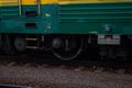 Detail of a green train chassis on rails at a train station Royalty Free Stock Photo