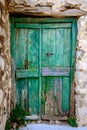 Detail of green wooden door in vintage stone wall Royalty Free Stock Photo