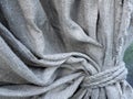 Detail of grey textured linen curtain. Concept of drapery, decoration by the coarse cloth Royalty Free Stock Photo