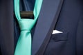 Detail of a groom`s dark blue costume and a green tie Royalty Free Stock Photo