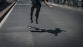 Detail of a guy performing a trick while skateboarding