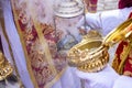 Detail of the hand of an altar boy or acolyte in a Holy Week procession filling one of the censers with incense