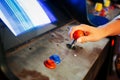 Detail On A Hand Holding Joystick Close To Blue And Red Button Controls Of An Old Vintage Arcade Video Game