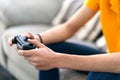 Detail Of The Hand With The Joystick Of A Young Guy Playing A Game On The Console In His Living Room
