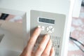 Detail of a hand pressing the button to select a stitch for machine sewing. Chart of sewing options for the electric machine. Royalty Free Stock Photo