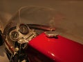 Detail of handlebars with speedometer and large red fuel tank of historical czechoslovak racing motorcycle Jawa 250 Royalty Free Stock Photo