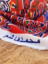 Detail of handmade cotton fabric on the sand. Chill out. Colorful Bedouin fabric. Arabic decoration and culture