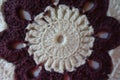 Detail of handmade maroon and white crochet pillow