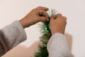 detail hands decorating christmas tree on hollidays