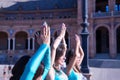 Detail of hands joined above the head of three middle-aged Hispanic women, wearing turquoise and rhinestone costumes, to dance