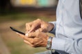 Detail of the hands of a Latino man using a mobile phone Royalty Free Stock Photo