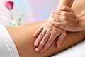 Detail of Hands massaging female hamstrings. Royalty Free Stock Photo