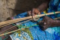 Detail of the hands of an old woman working in front of her hut at the village of Eticoga in the island of Orango Royalty Free Stock Photo