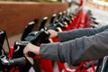 Hands taking a bike from a rental bicycle parking Royalty Free Stock Photo