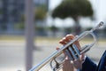 Detail of the hands of a trumpet player playing the musical instrument. The hand raises and lowers the pistons of the trumpet. Royalty Free Stock Photo