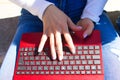 Detail of the hands of a woman teleworking from the terrace of her home anywhere in the world Royalty Free Stock Photo