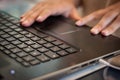 Detail of hands working on computer keyboard