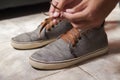 Detail of the hands of a young Brazilian man tying the tennis shoe Royalty Free Stock Photo