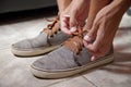 Detail of the hands of a young Brazilian man tying the tennis shoe Royalty Free Stock Photo