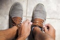 Detail of the hands of a young Brazilian man tying the tennis shoe Royalty Free Stock Photo