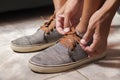 Detail of the hands of a young Brazilian man tying the tennis shoe Royalty Free Stock Photo