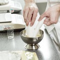 Detail of hands of young pharmacist