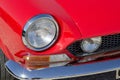 Detail of an headlight of a vintage italian red sport car Royalty Free Stock Photo