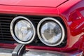 Detail of an headlight of a vintage italian red sport car Royalty Free Stock Photo