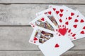 Detail of heart deck poker playing cars on wooden table